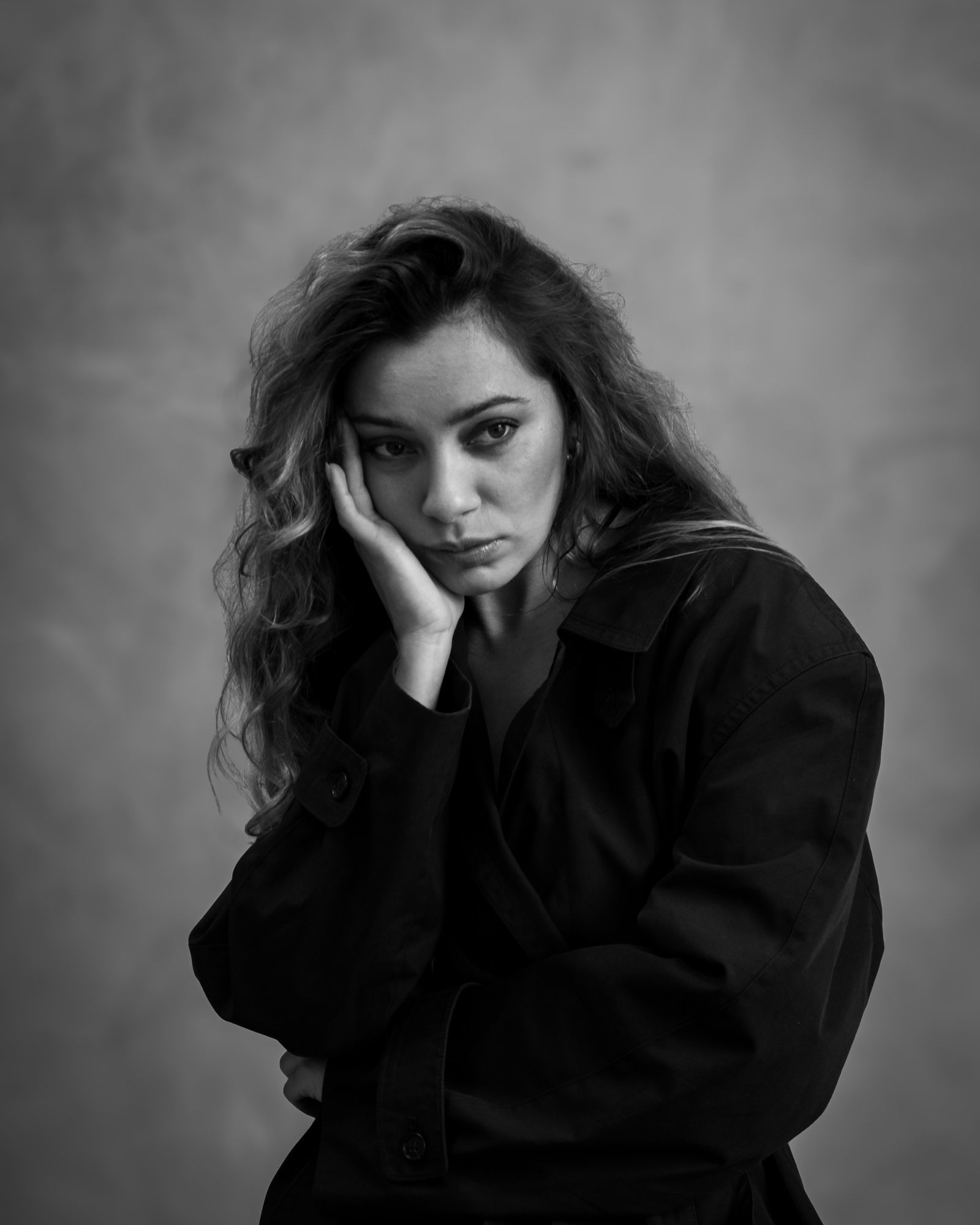 Black and white portrait of a woman deep in thought.